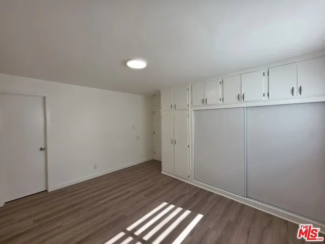 a view of an empty room and wooden floor
