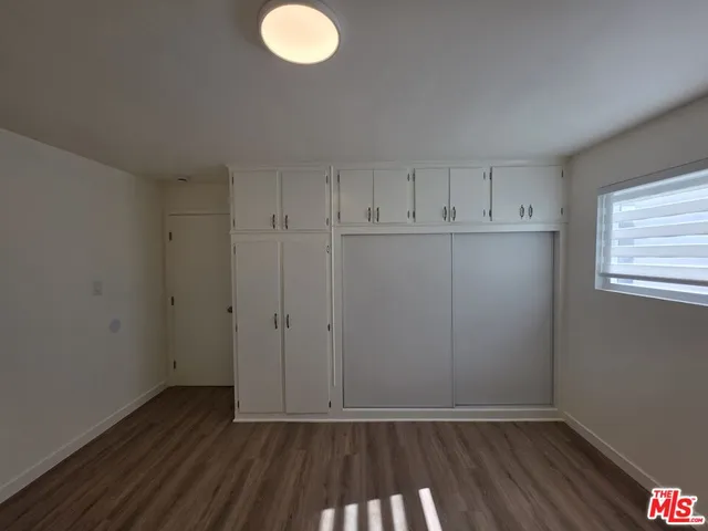 a view of room with window and hardwood floor