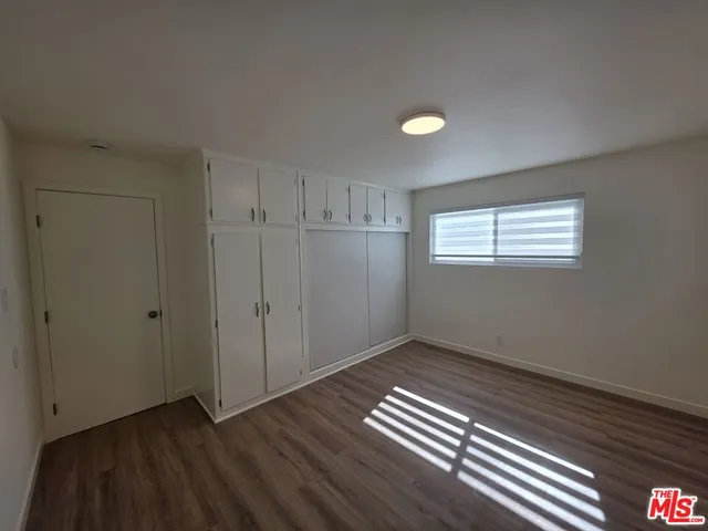 a view of wooden floor and windows in a room