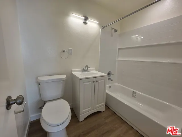 a bathroom with a granite countertop toilet a sink and bathtub