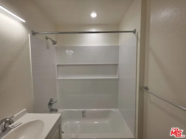 a bathroom with a tub and shower