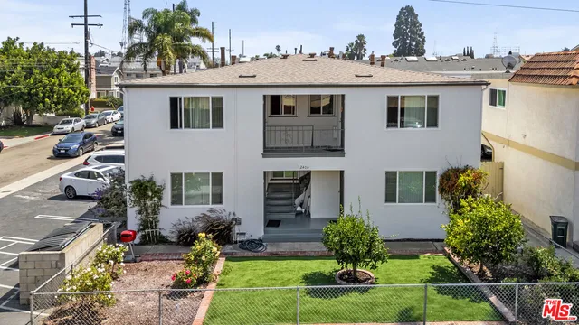 a front view of a house with yard and green space