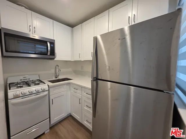 a white refrigerator freezer sitting inside of a kitchen
