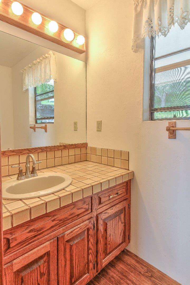 96 Robley Road Salinas, CA 93908 - Photo 17 of 41 a bathroom with a granite countertop sink and a large mirror