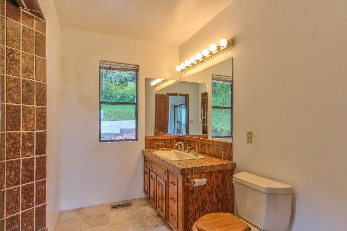 96 Robley Road Salinas, CA 93908 - Photo 23 of 41 a bathroom with a sink a toilet and a mirror