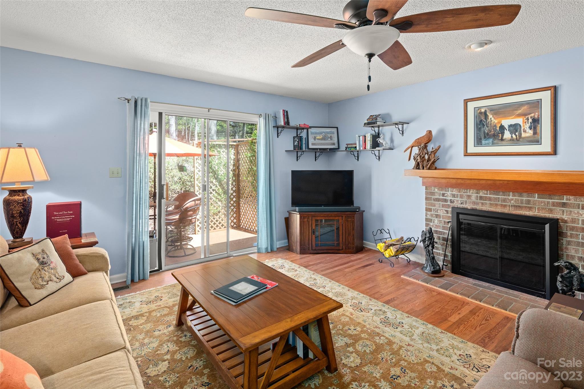 104 Hunter's Trail, Unit 17 Tryon, NC 28782 - Photo 5 of 27 a living room with furniture a flat screen tv and a fireplace