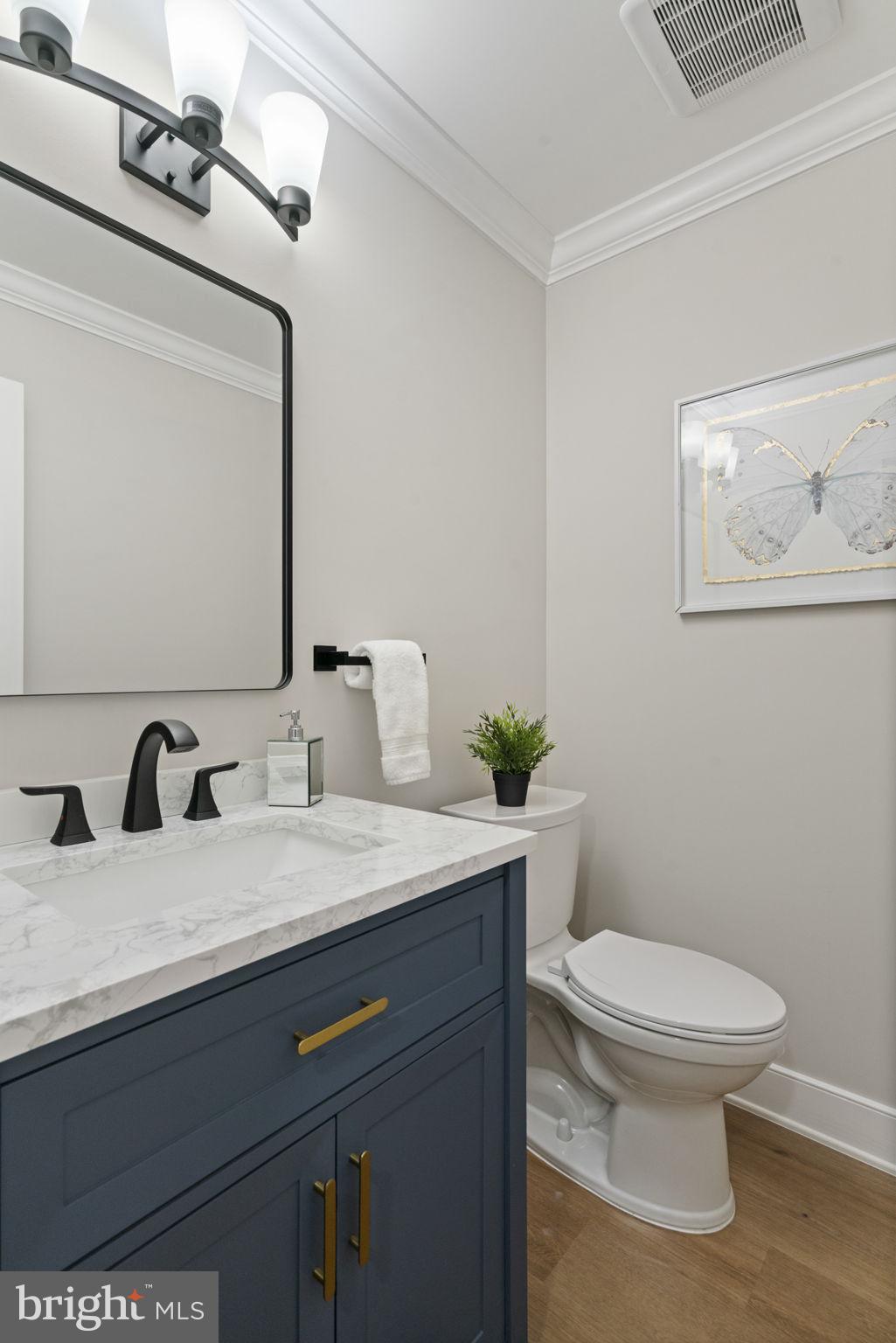 2891 Kelly Square Vienna, VA 22181 - Photo 19 of 39 a bathroom with a granite countertop toilet sink and mirror