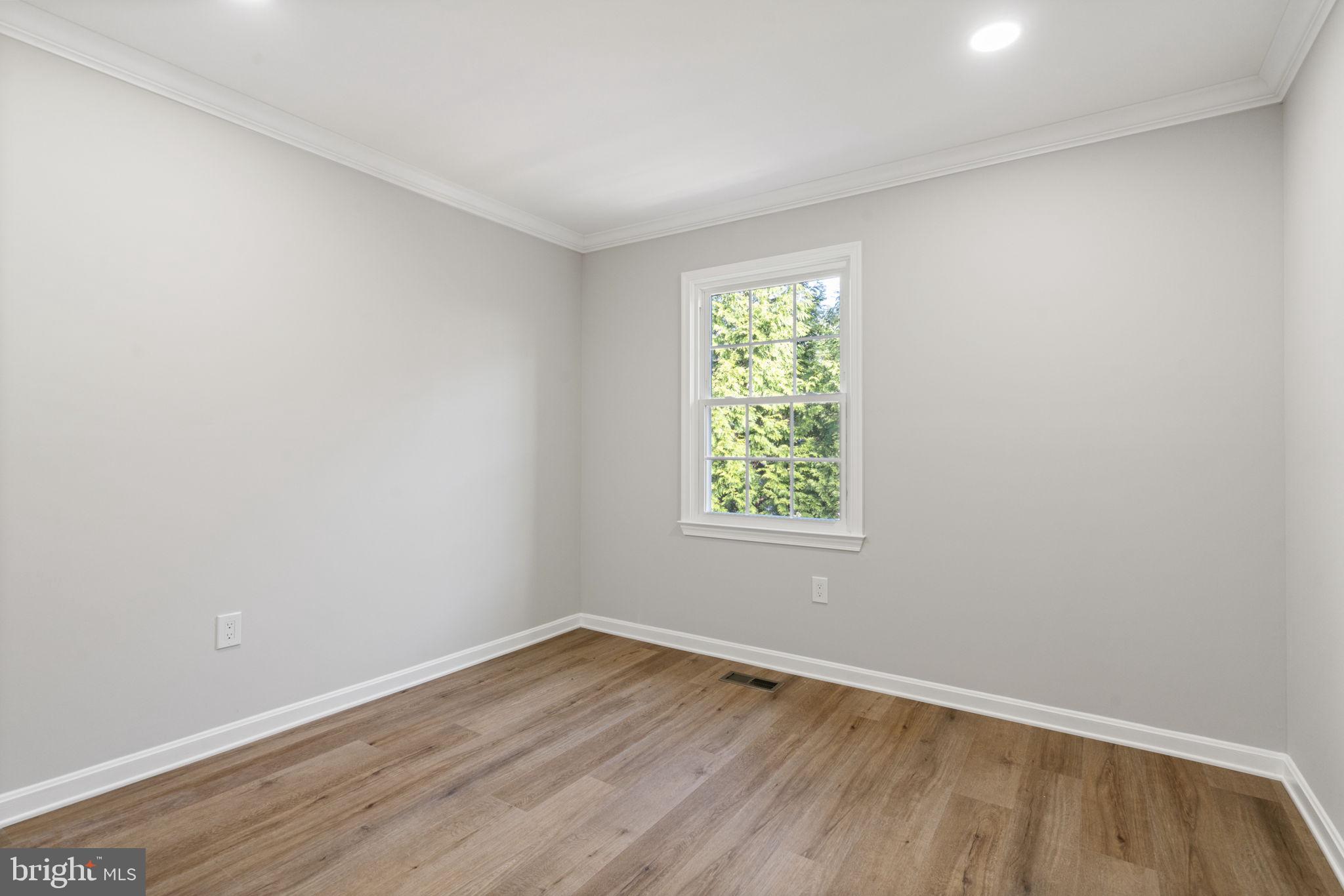 2891 Kelly Square Vienna, VA 22181 - Photo 22 of 39 an empty room with wooden floor and windows