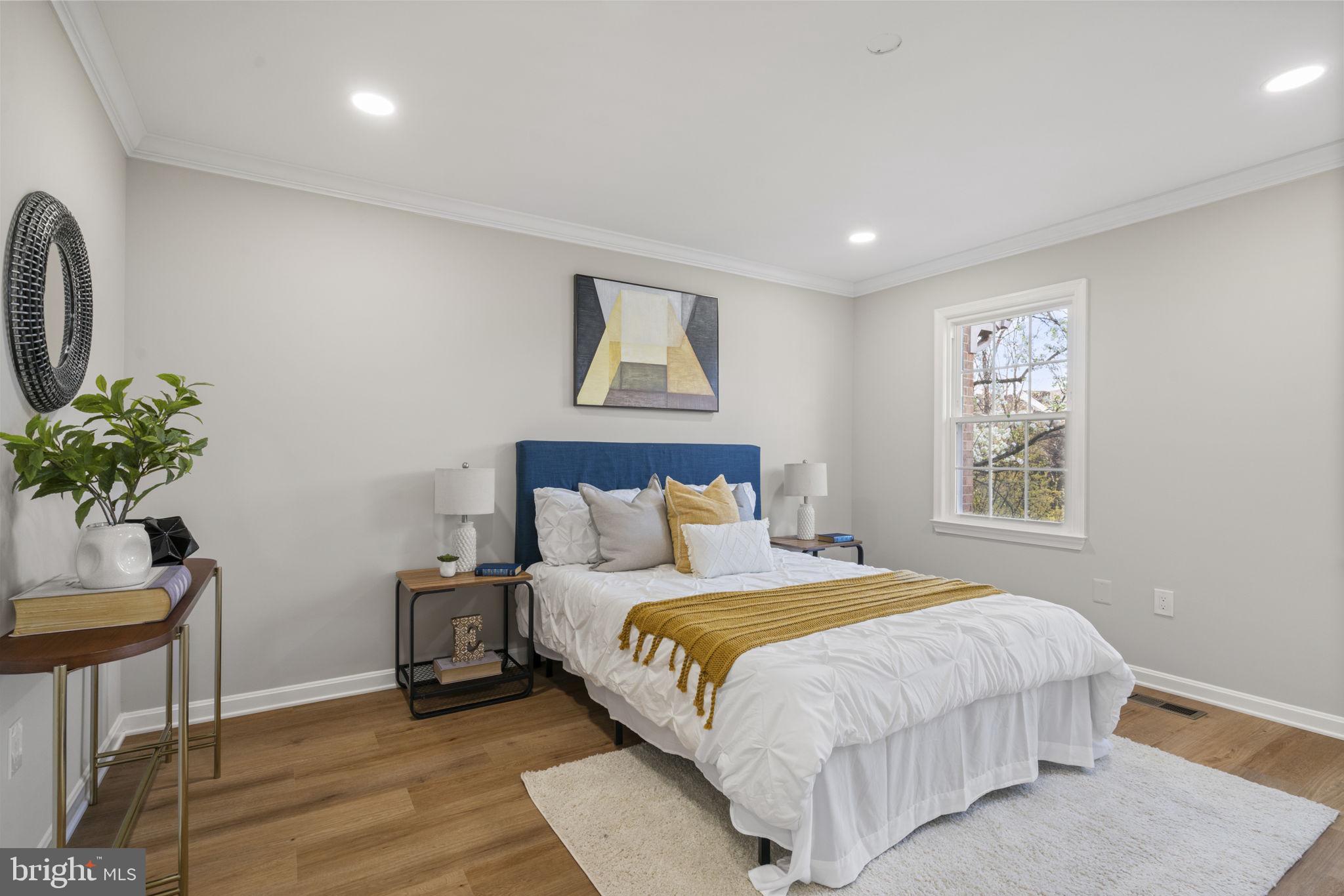 2891 Kelly Square Vienna, VA 22181 - Photo 26 of 39 a bedroom with a large bed and a potted plant