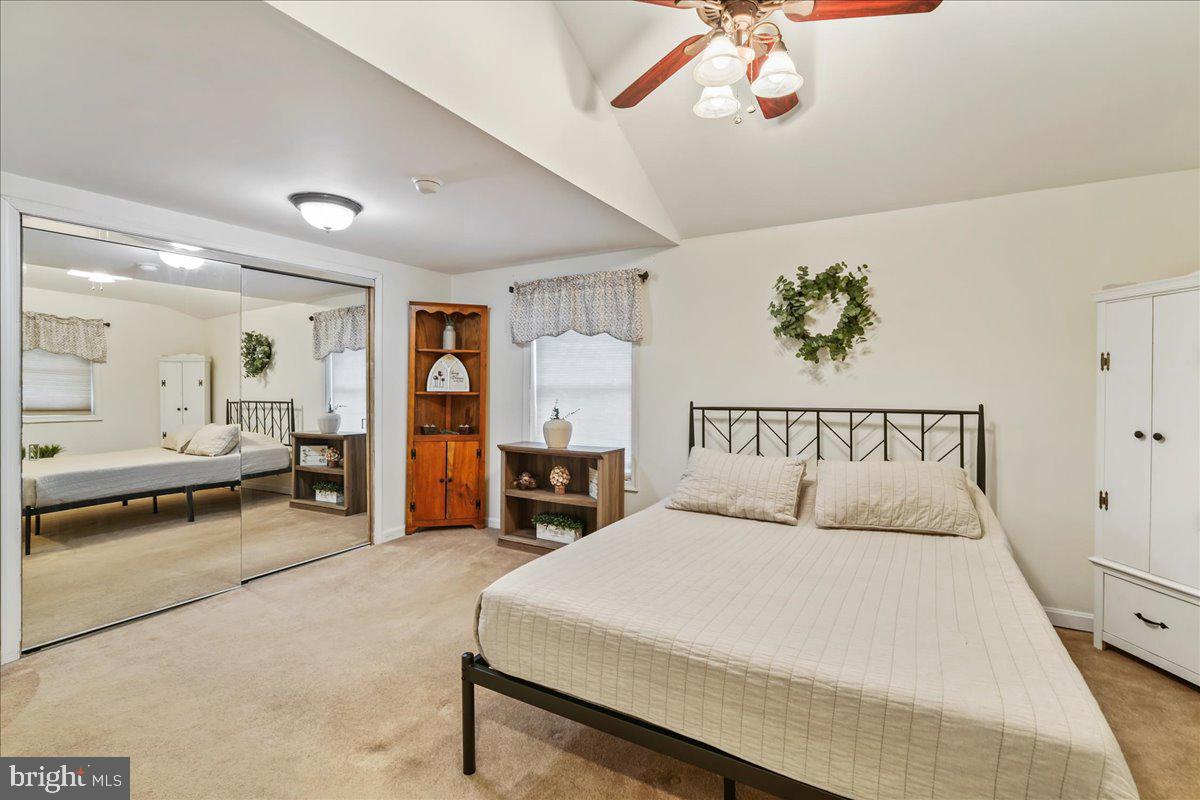 51 Carter Road Rising Sun, MD 21911 - Photo 14 of 17 a bedroom with a large bed and a chandelier