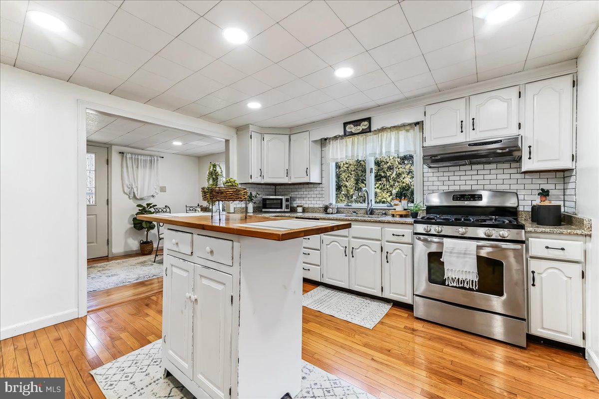 51 Carter Road Rising Sun, MD 21911 - Photo 6 of 17 a kitchen with stainless steel appliances granite countertop a stove a sink and a microwave
