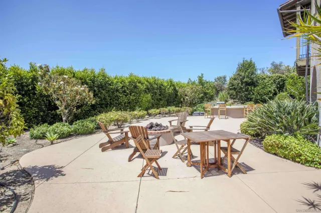 a kitchen with granite countertop a refrigerator and cabinets