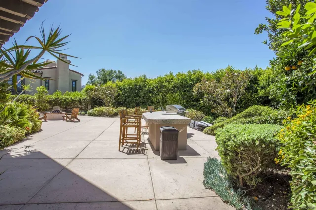 a kitchen with stainless steel appliances granite countertop a stove top oven a sink a counter space and cabinets