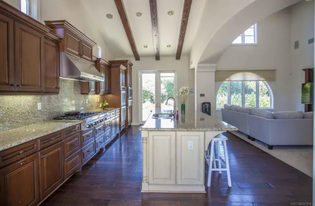 a bedroom with a bed and a flat screen tv in the background