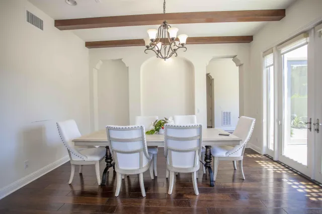 a bedroom with a large bed and a flat tv screen