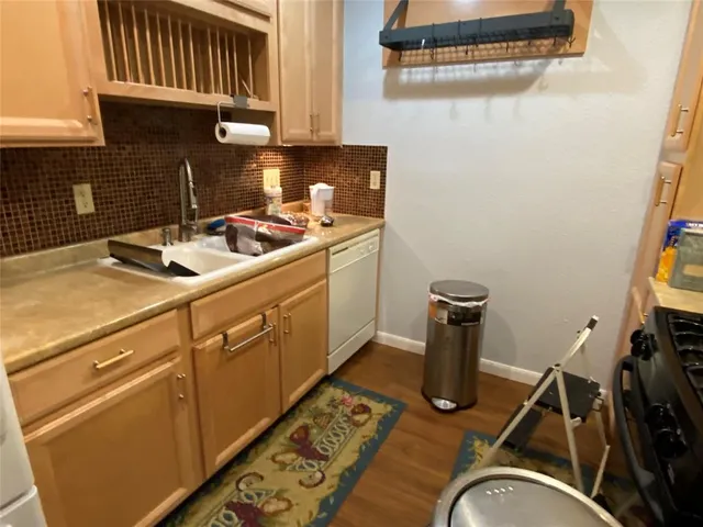 a kitchen with sink cabinets and appliances