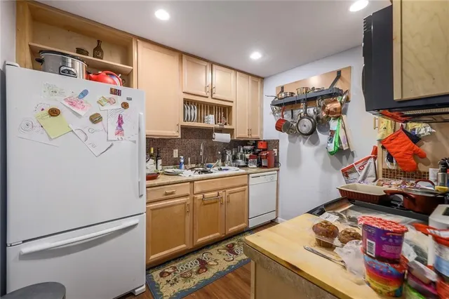 a kitchen with stainless steel appliances granite countertop a refrigerator and a sink