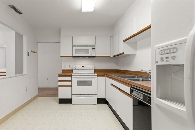 a kitchen with cabinets and appliances