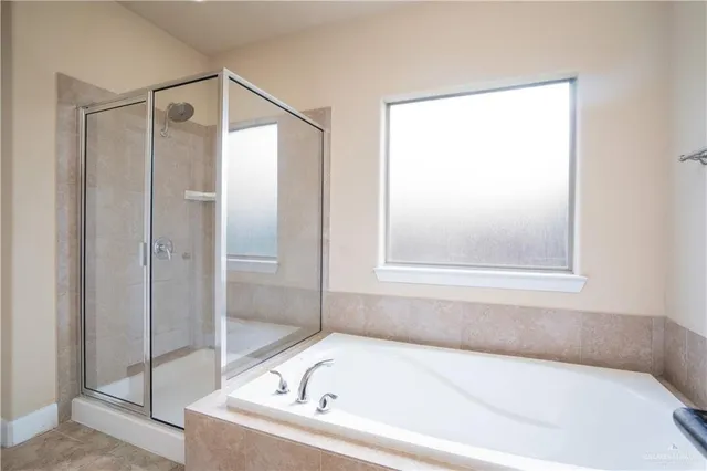 a white bath tub sitting next to a shower