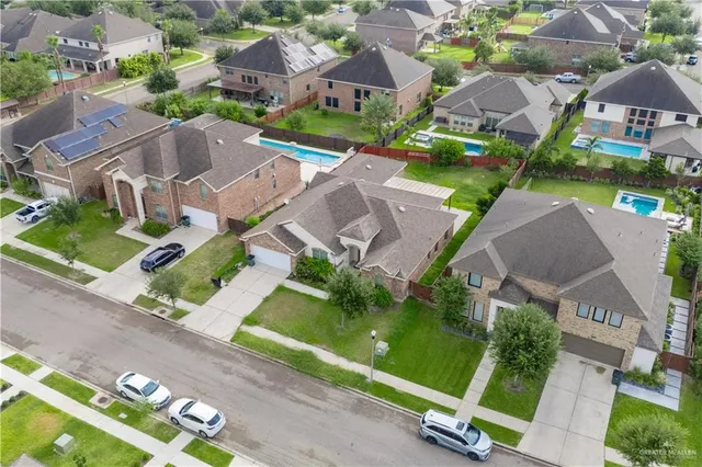 an aerial view of residential houses with outdoor space and street view