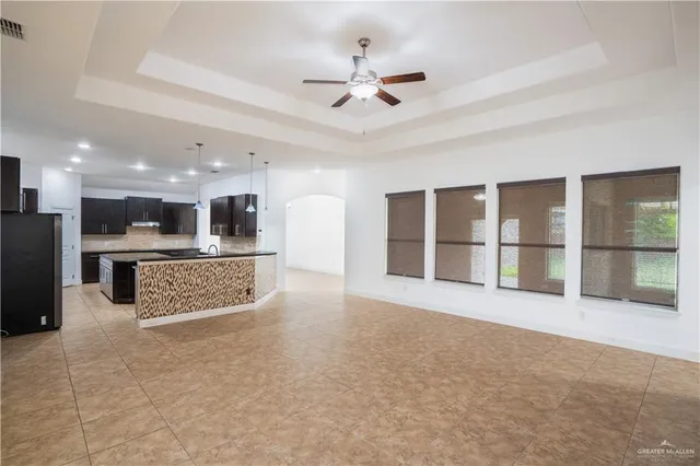 a view of an empty room with a kitchen