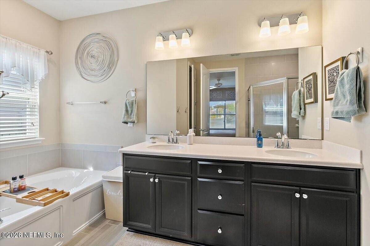 2393 Reese Way Jacksonville, FL 32246 - Photo 11 of 30 a spacious bathroom with a double vanity sink and a mirror