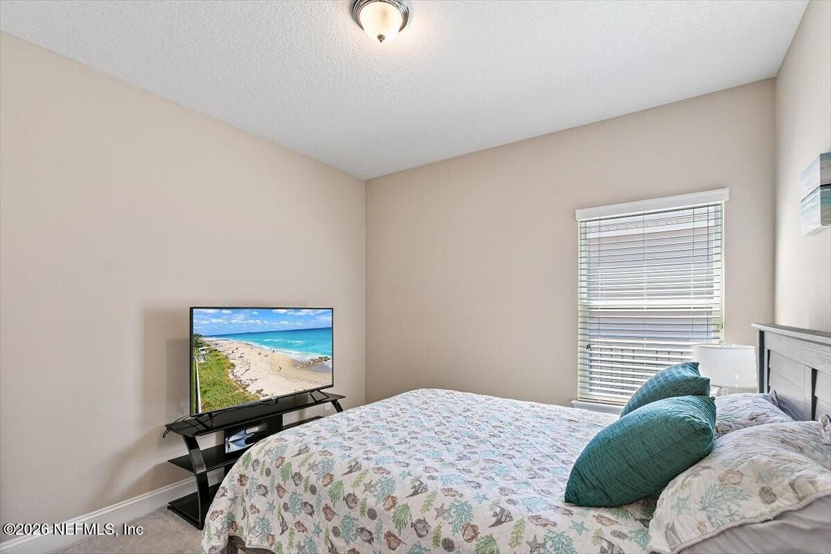 2393 Reese Way Jacksonville, FL 32246 - Photo 13 of 30 a bedroom with a bed and a flat screen tv