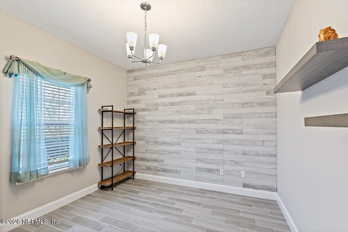 2393 Reese Way Jacksonville, FL 32246 - Photo 3 of 30 a view of empty room with wooden floor and fan