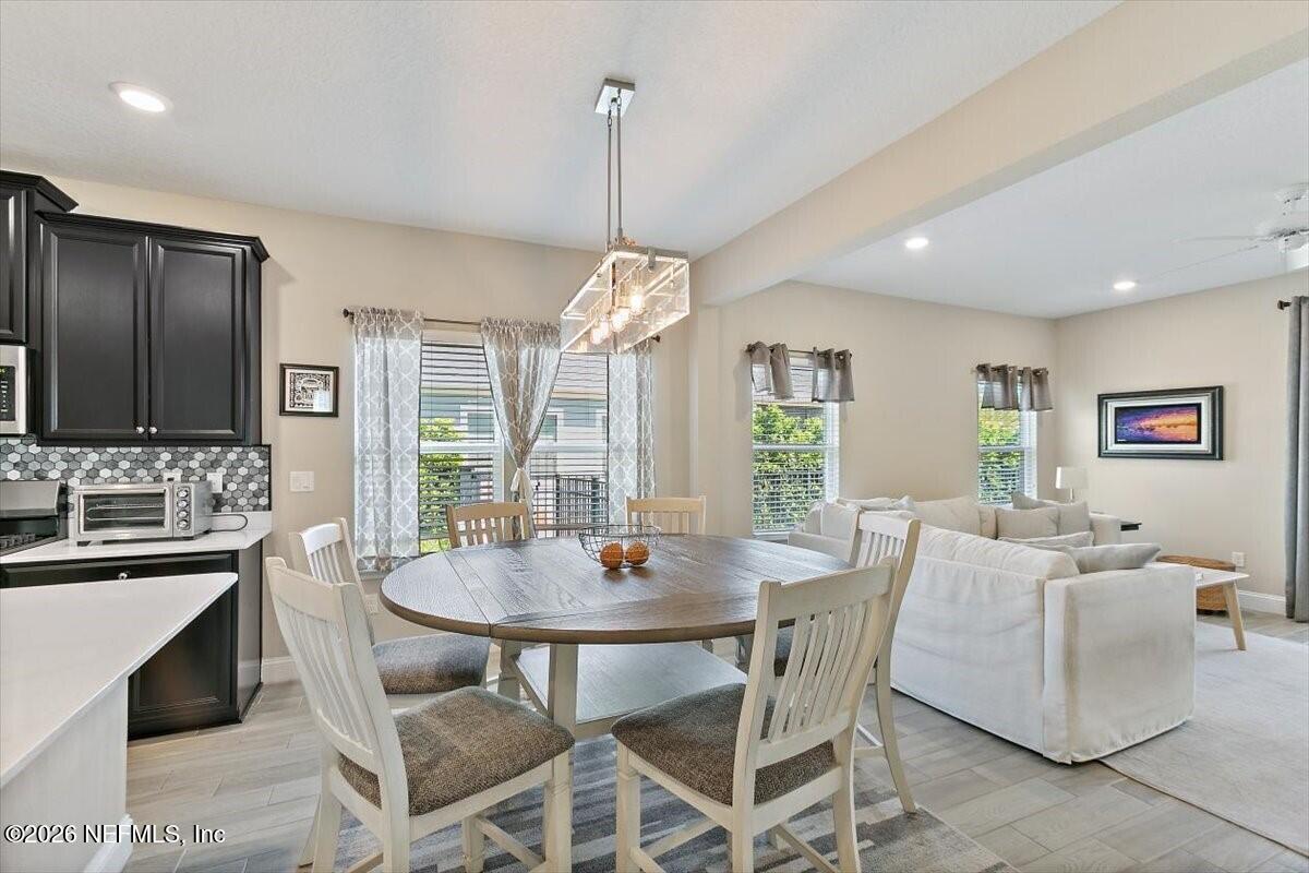 2393 Reese Way Jacksonville, FL 32246 - Photo 6 of 30 a view of a dining room with furniture window and wooden floor