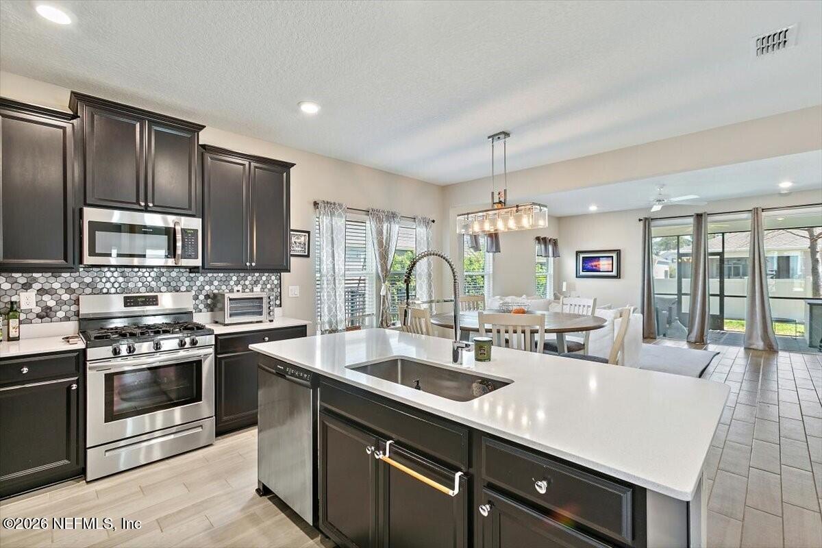 2393 Reese Way Jacksonville, FL 32246 - Photo 8 of 30 a kitchen with stainless steel appliances granite countertop a sink stove and refrigerator