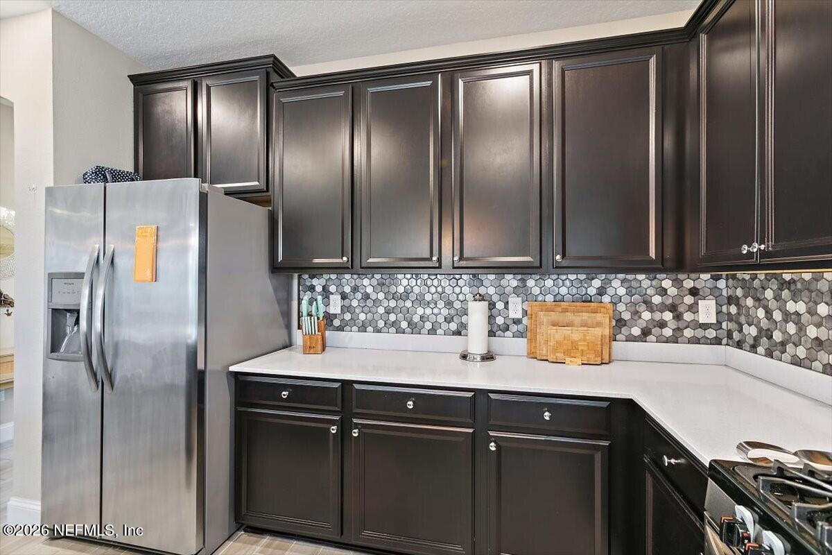 2393 Reese Way Jacksonville, FL 32246 - Photo 9 of 30 a kitchen with stainless steel appliances granite countertop a sink and a refrigerator