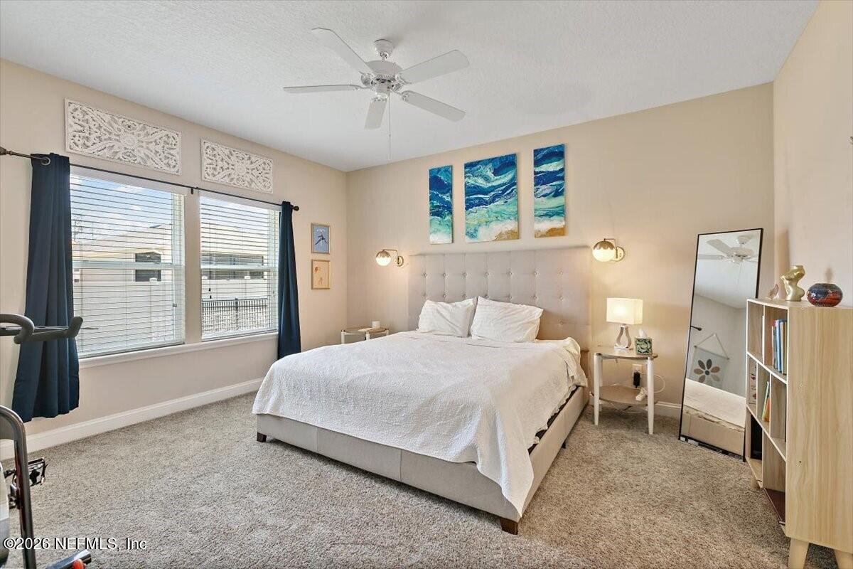 2393 Reese Way Jacksonville, FL 32246 - Photo 10 of 30 a spacious bedroom with a bed and a large window