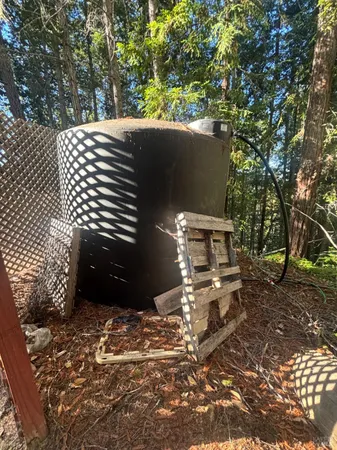 a view of a patio with table and chairs with wooden fence and plants