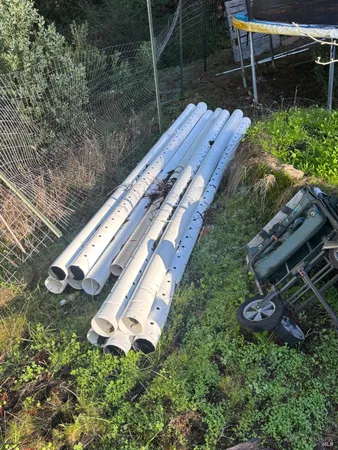 a view of a backyard with plants and outdoor seating