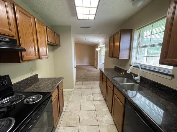 a kitchen with a sink appliances and cabinets