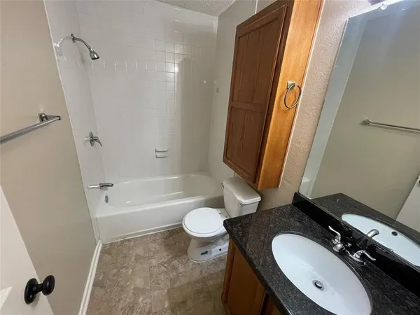 a bathroom with a sink a toilet a mirror and shower