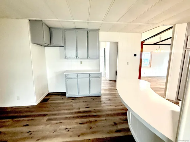 a view of a kitchen with wooden floor and staircase