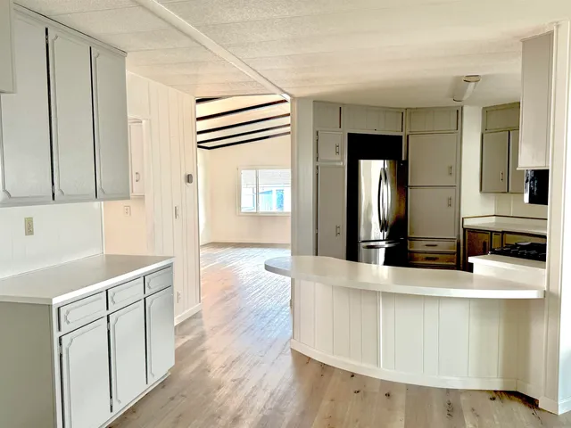 a view of a kitchen counter space with wooden floor