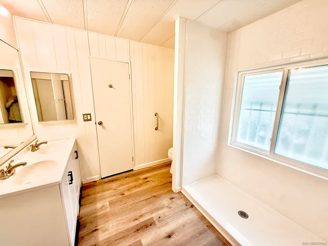 a bathroom with a tub sink and a mirror