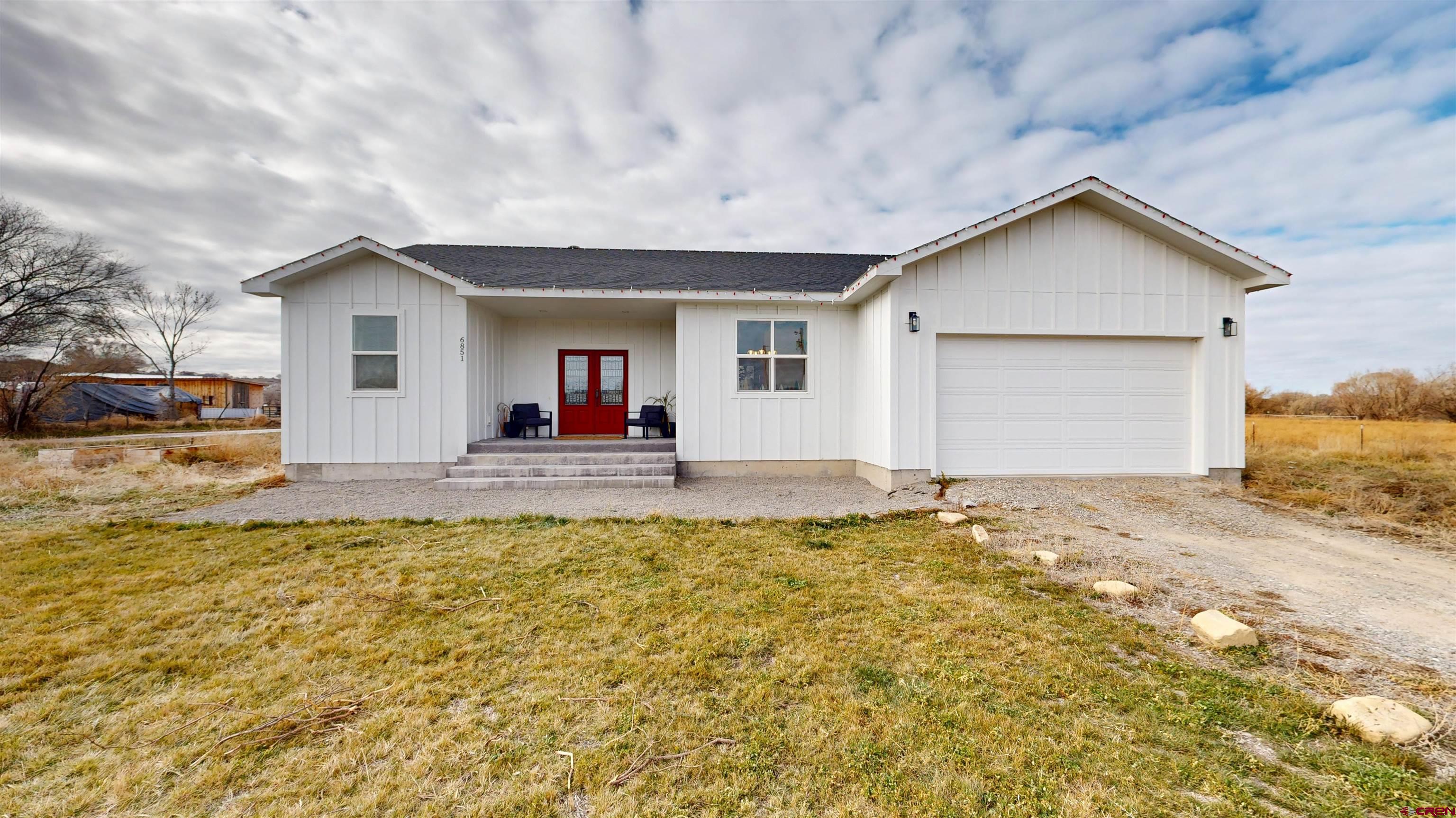 6851 Church Road Olathe, CO 81425 - Photo 1 of 27 a view of a house with a yard