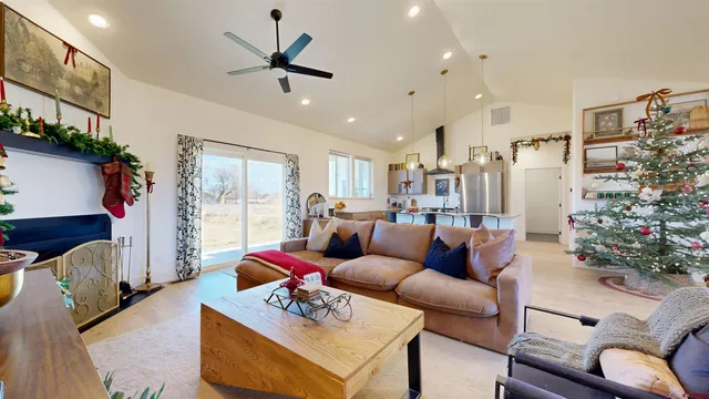 a living room with furniture flowers and a chandelier