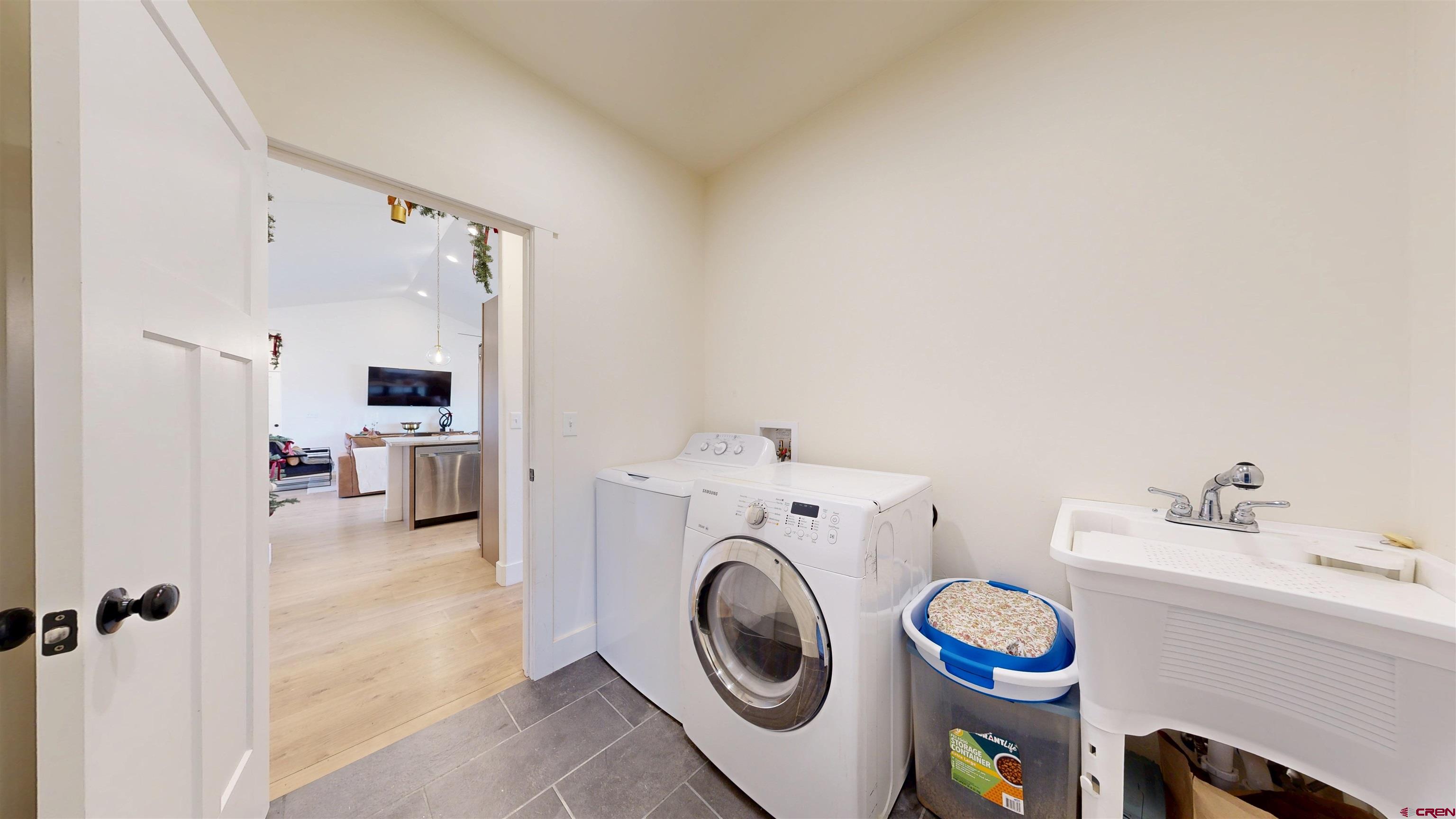 6851 Church Road Olathe, CO 81425 - Photo 12 of 27 a utility room with sink dryer and washer