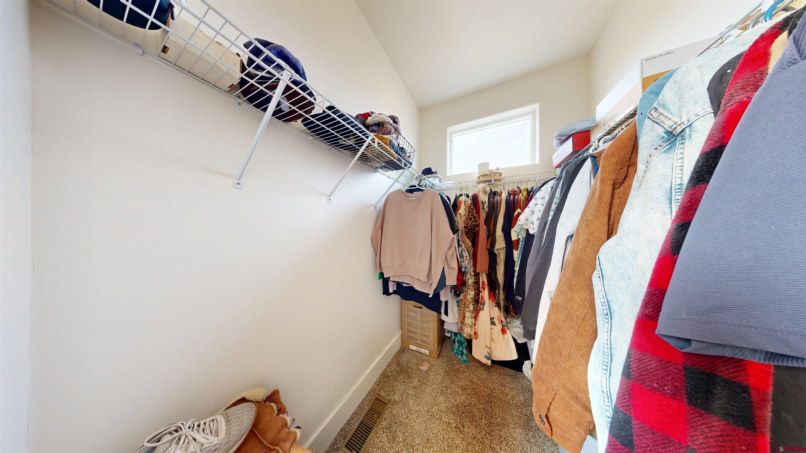 6851 Church Road Olathe, CO 81425 - Photo 15 of 27 a view of walk in closet with clothes