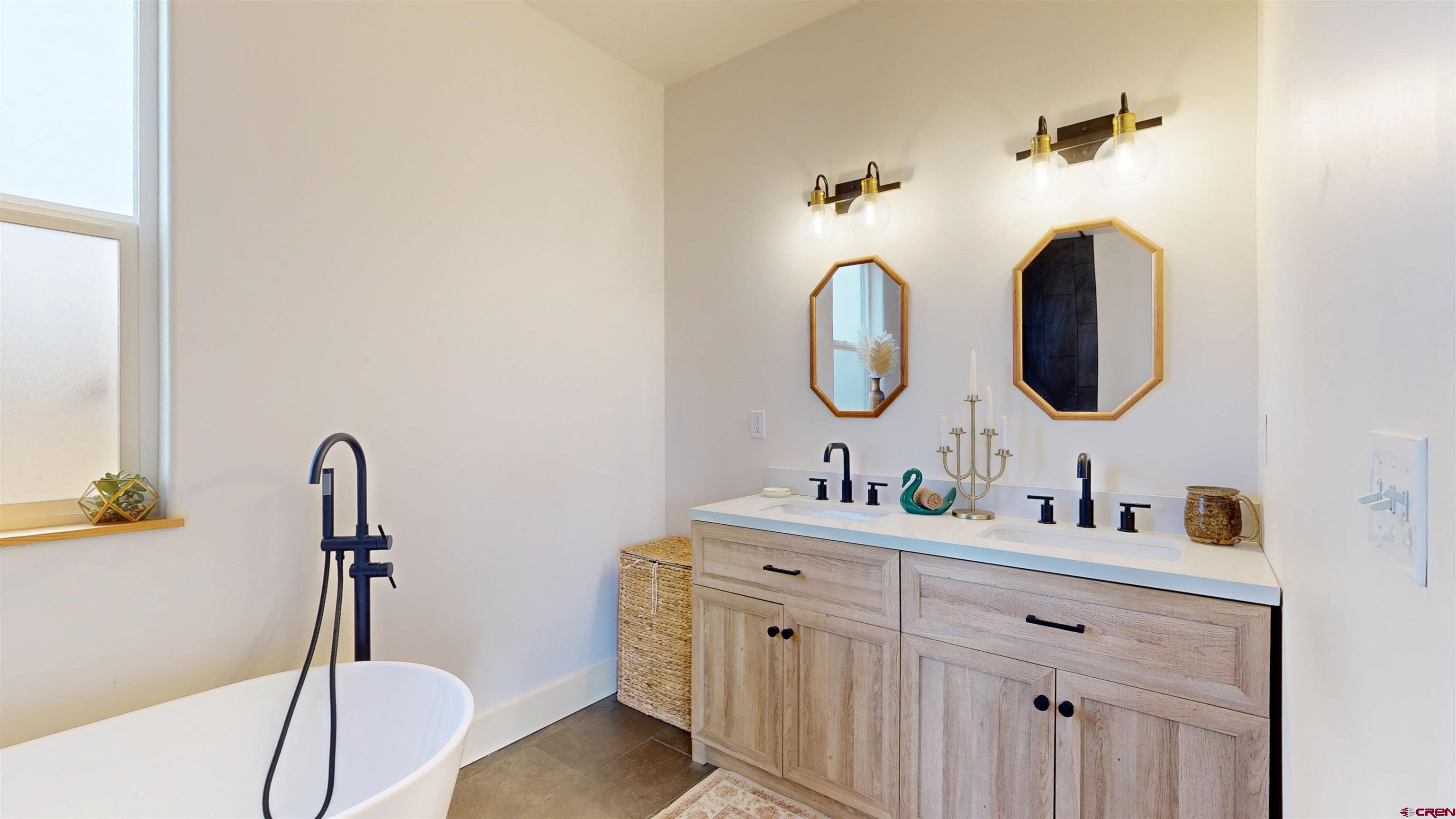 6851 Church Road Olathe, CO 81425 - Photo 18 of 27 a bathroom with a sink and a mirror