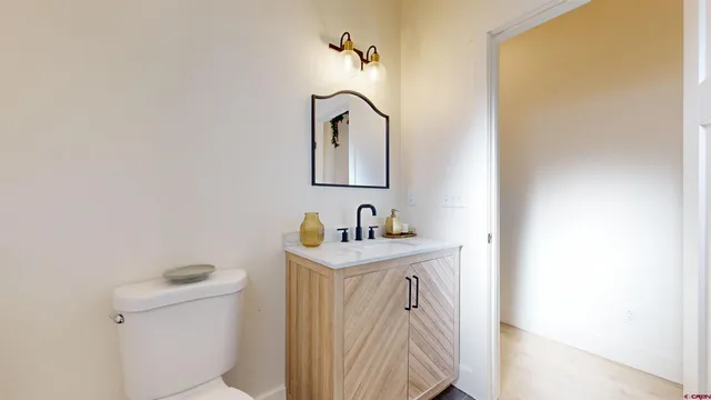 a bathroom with a sink a toilet and mirror