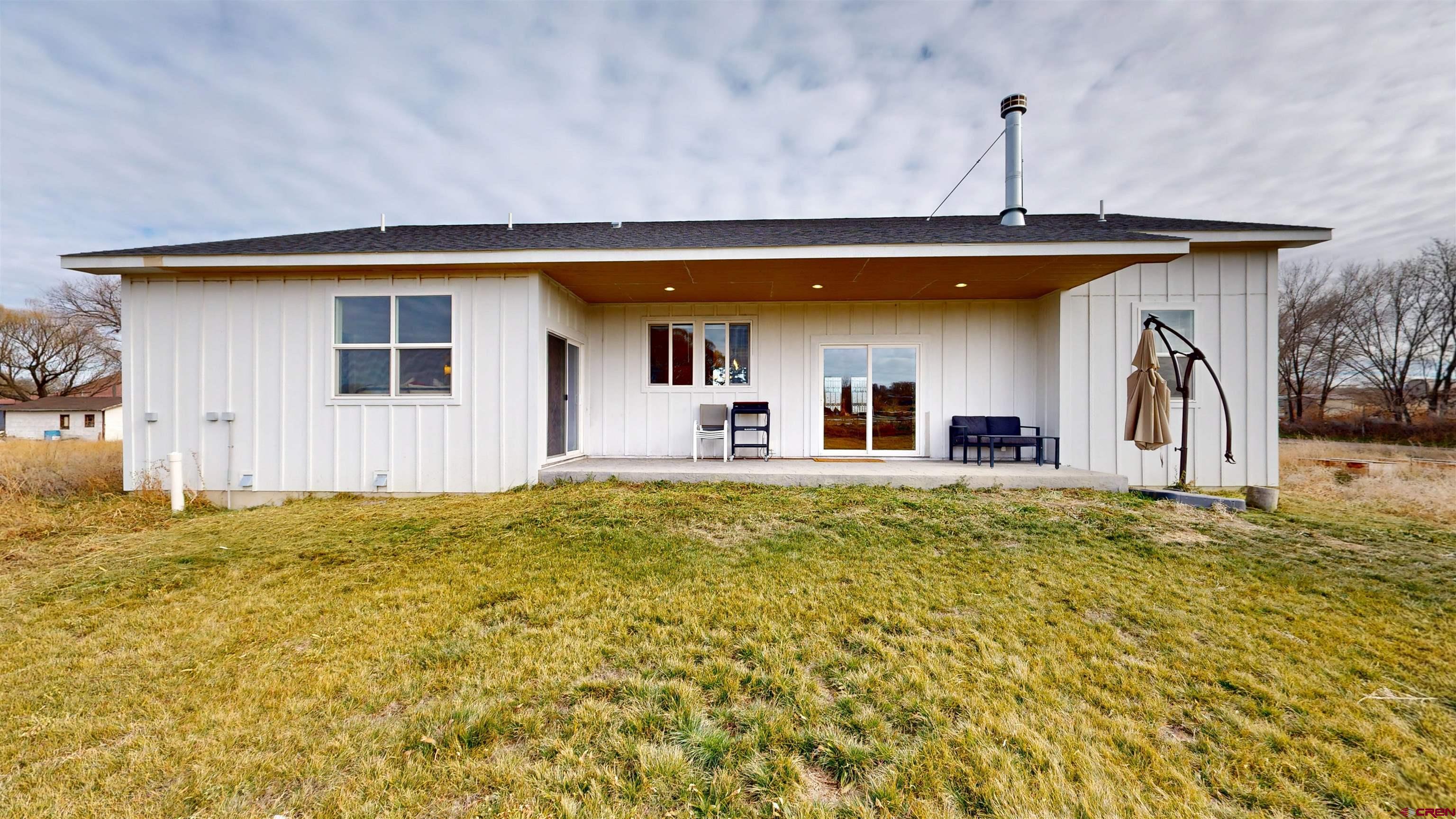 6851 Church Road Olathe, CO 81425 - Photo 4 of 27 a front view of a house with a yard