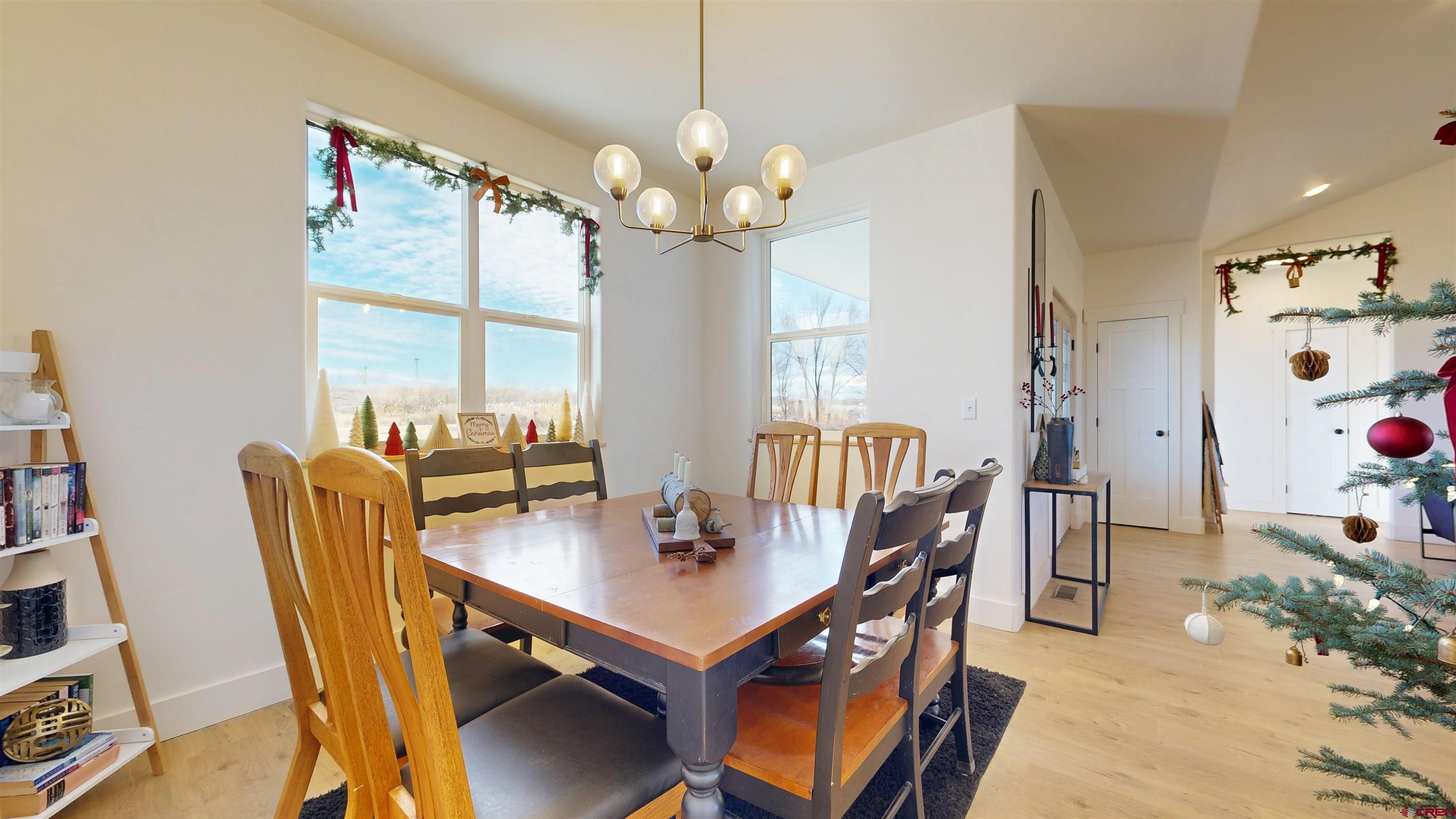 6851 Church Road Olathe, CO 81425 - Photo 8 of 27 a view of a dining room with furniture a chandelier and wooden floor