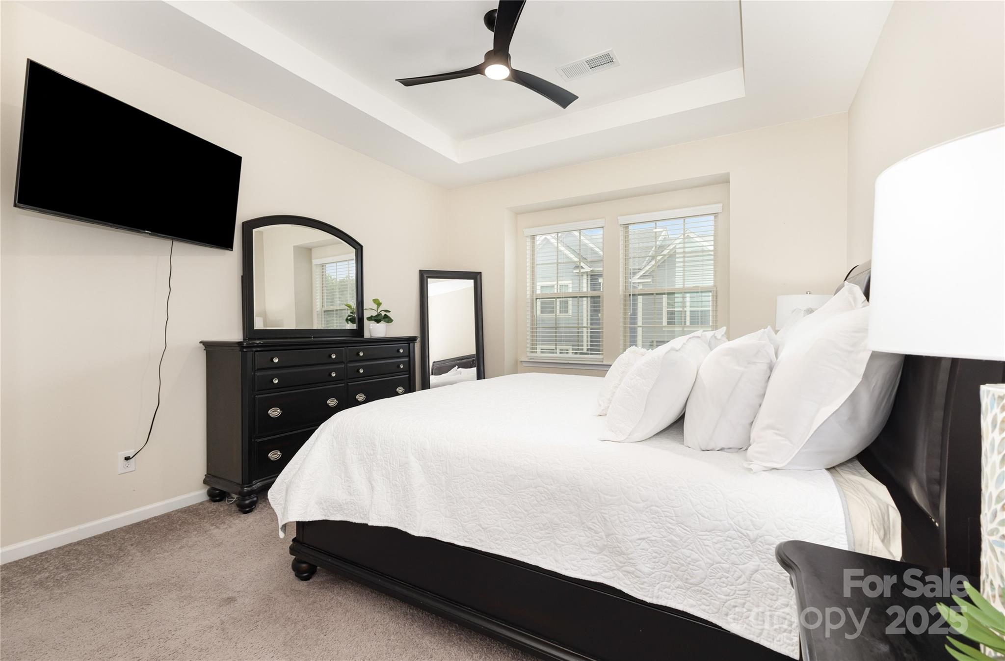 717 Swift Run Tega Cay, SC 29708 - Photo 17 of 39 a bedroom with a bed and a flat tv screen on dresser