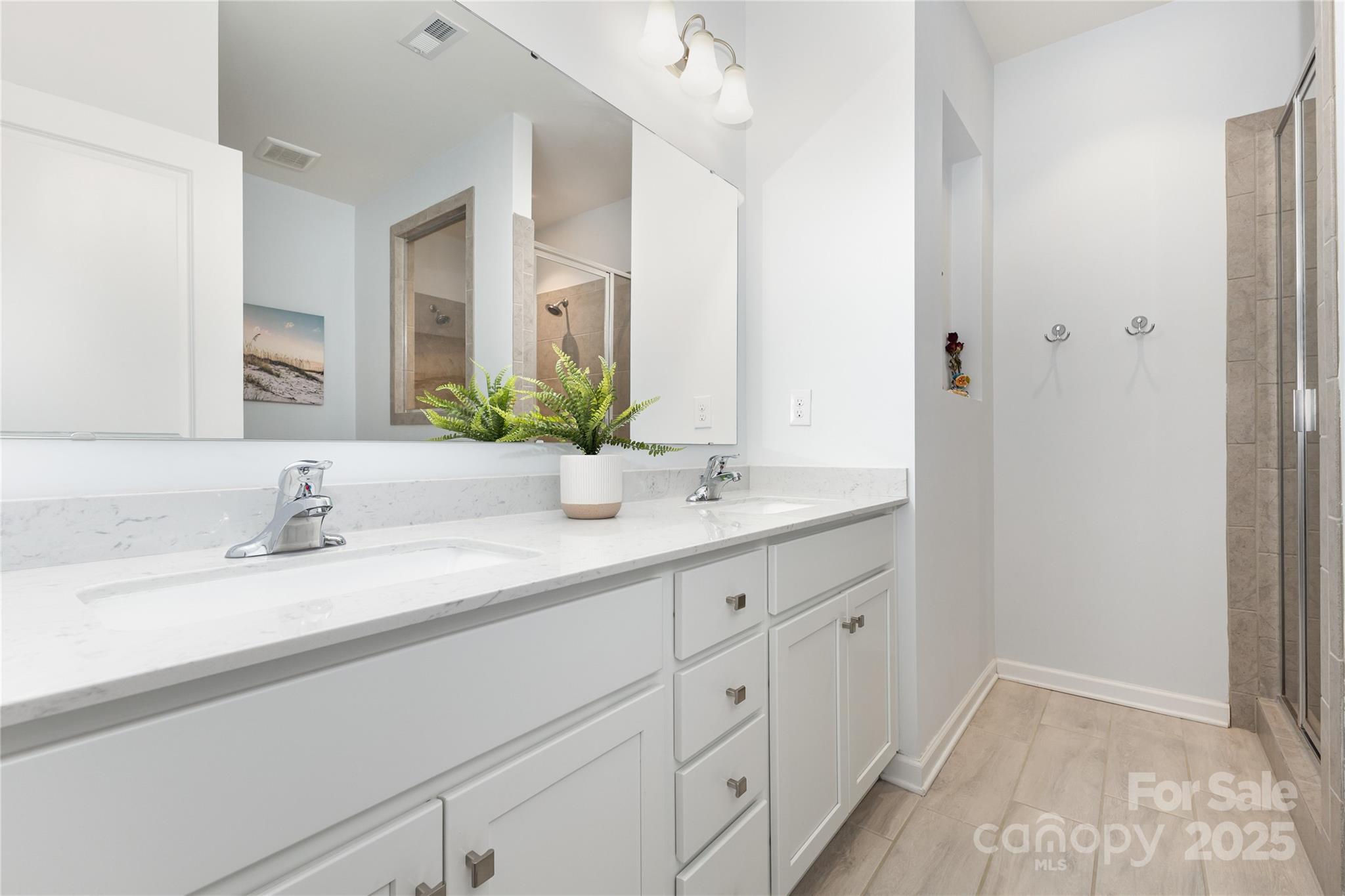 717 Swift Run Tega Cay, SC 29708 - Photo 18 of 39 a bathroom with a double vanity sink and a mirror
