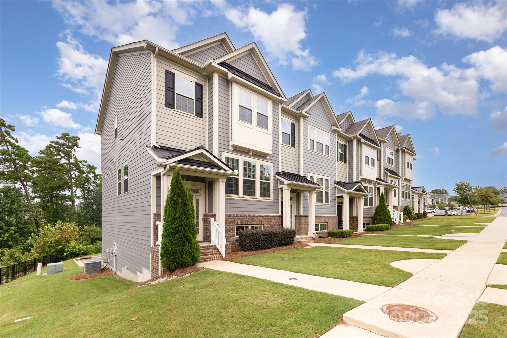 717 Swift Run Tega Cay, SC 29708 - Photo 39 of 39 a view of a white house next to a yard with big trees
